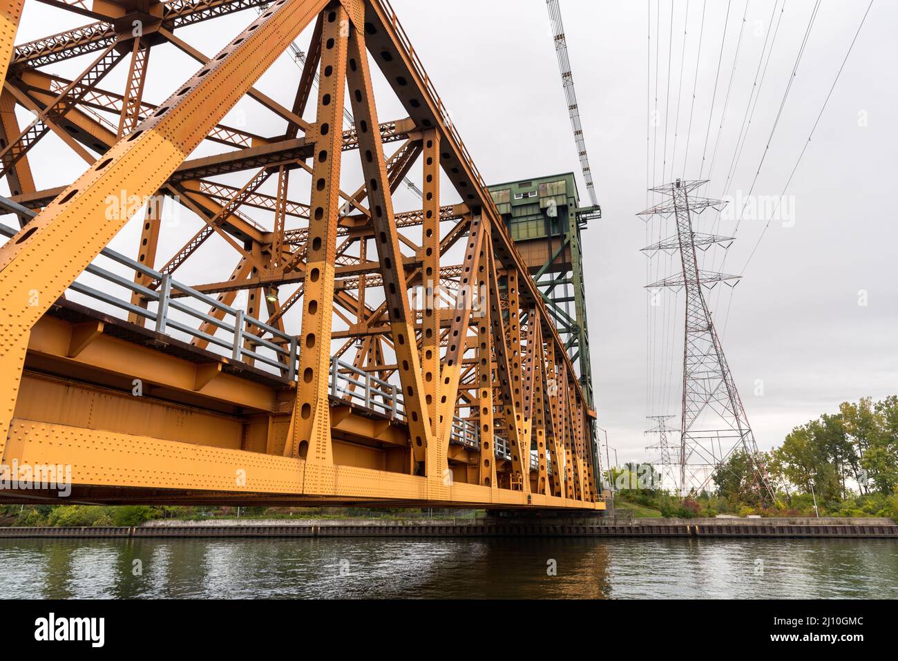 Low angle view of a vertical lift road bridge over a canal Stock Photo