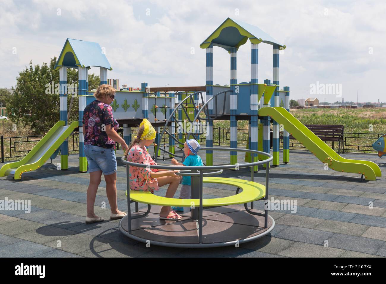 Family on a new playground on Kirov street in the village of Uyutnoye, Evpatoria, Crimea, Russia Stock Photo
