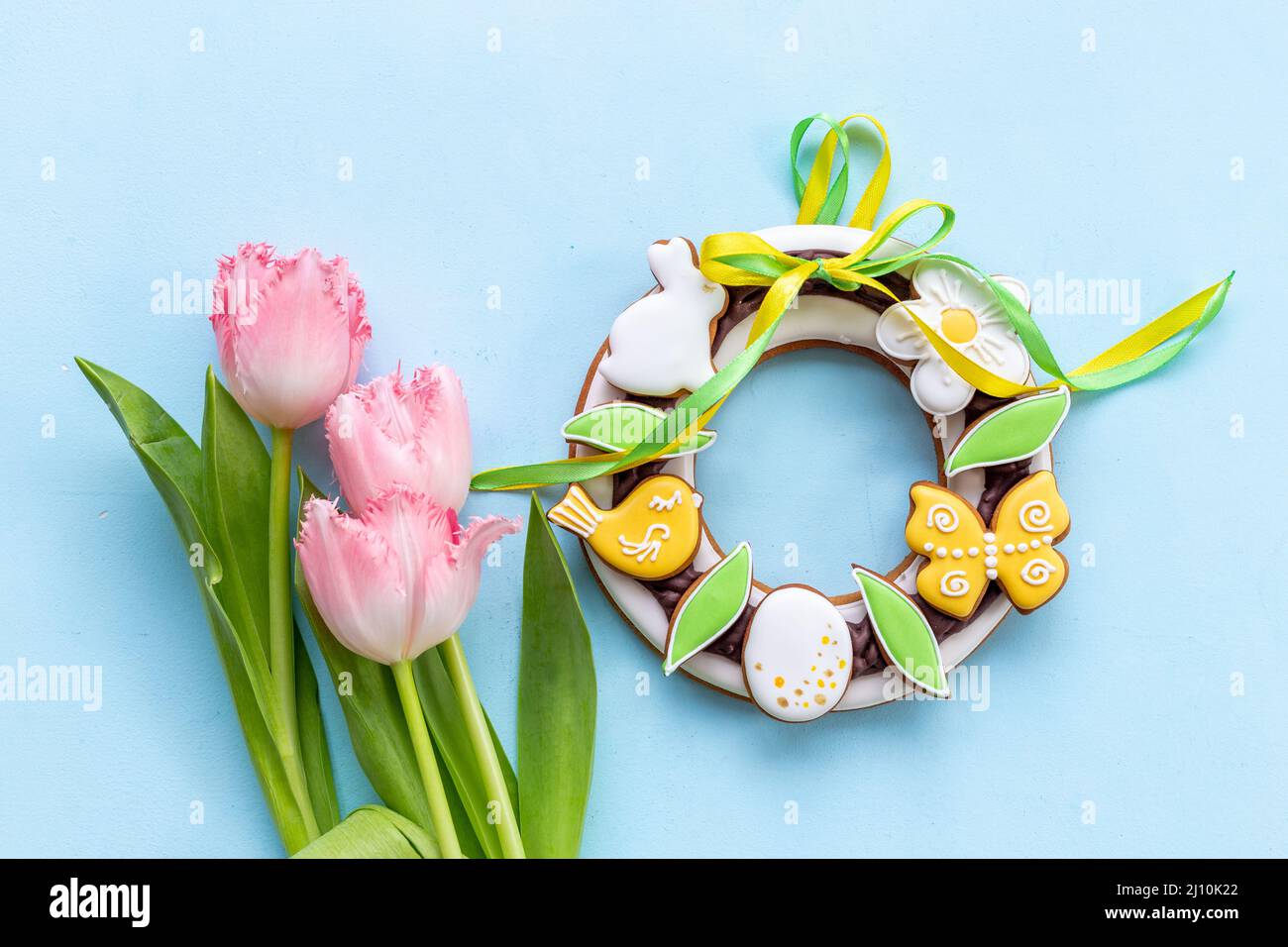 Happy Easter with pink tulips and cookies. Easter background Stock Photo