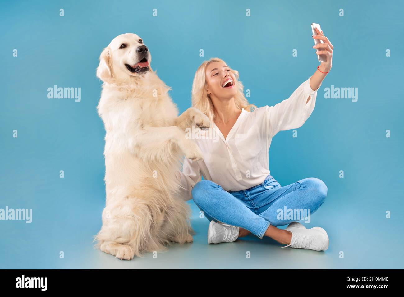 Young woman taking selfie with her dog Stock Photo