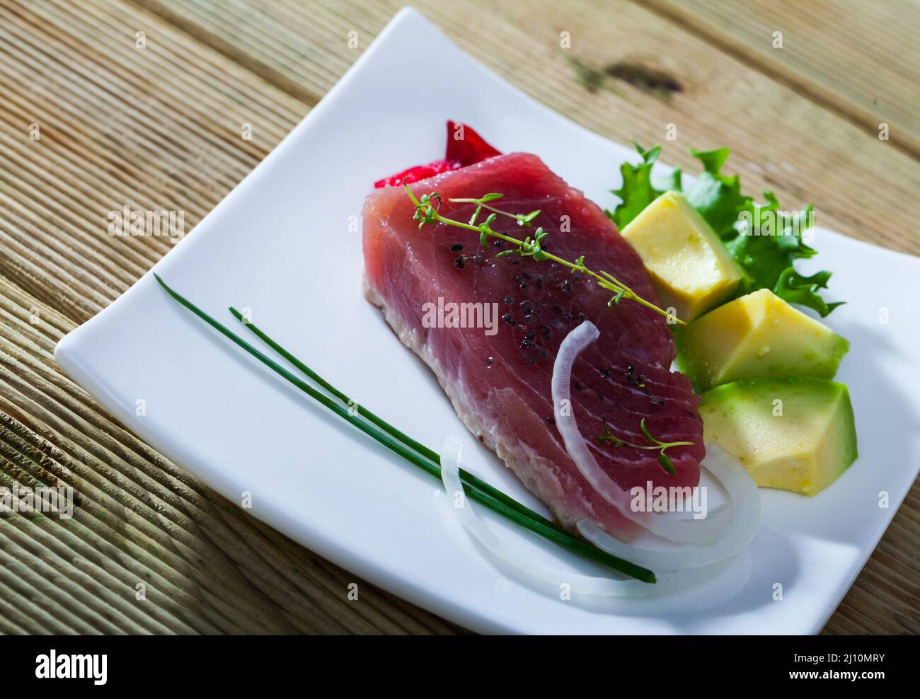 Tuna tataki with avocado, greens Stock Photo Alamy