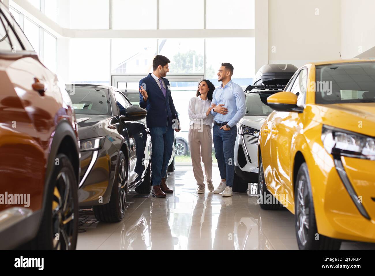 Arab man and woman choosing car at auto dealership Stock Photo Alamy