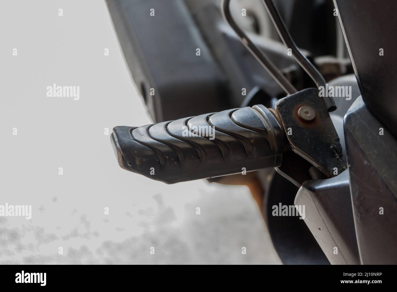 close up of motorcycle foot peg made of iron and black rubber Stock Photo