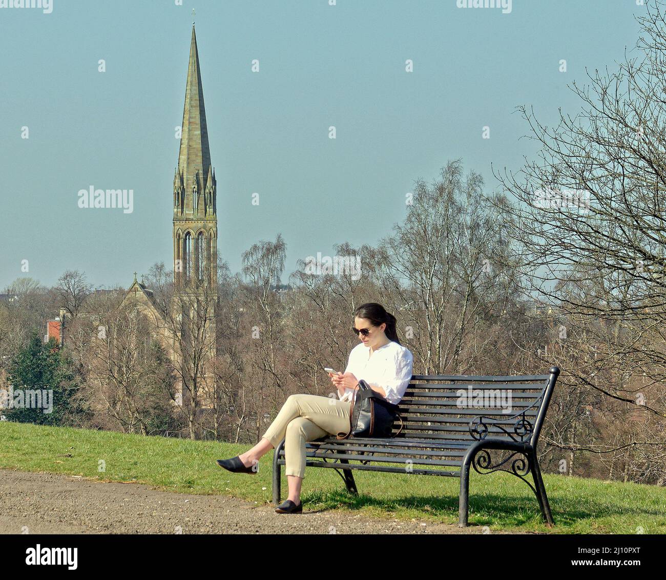 Glasgow, Scotland, UK 21st March, 2022. UK  Weather: : Another Sunny day saw summer like weather with rising temperatures over the city and in the city centre. Queens park with its elevated height and splendid views of the city centre and the victorian local architecture always fills with people when the sun shines. Credit Gerard Ferry/Alamy Live News Stock Photo