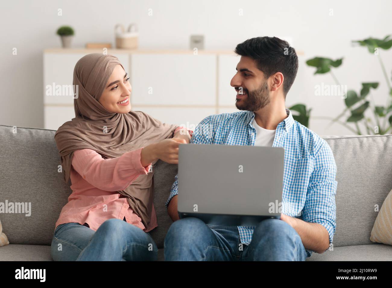 Middle Eastern Husband And Wife Using Laptop Computer Indoor Stock ...