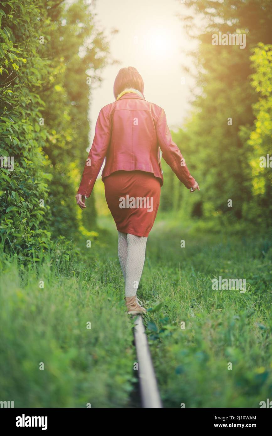 Girl balancing on a railroad track Stock Photo - Alamy