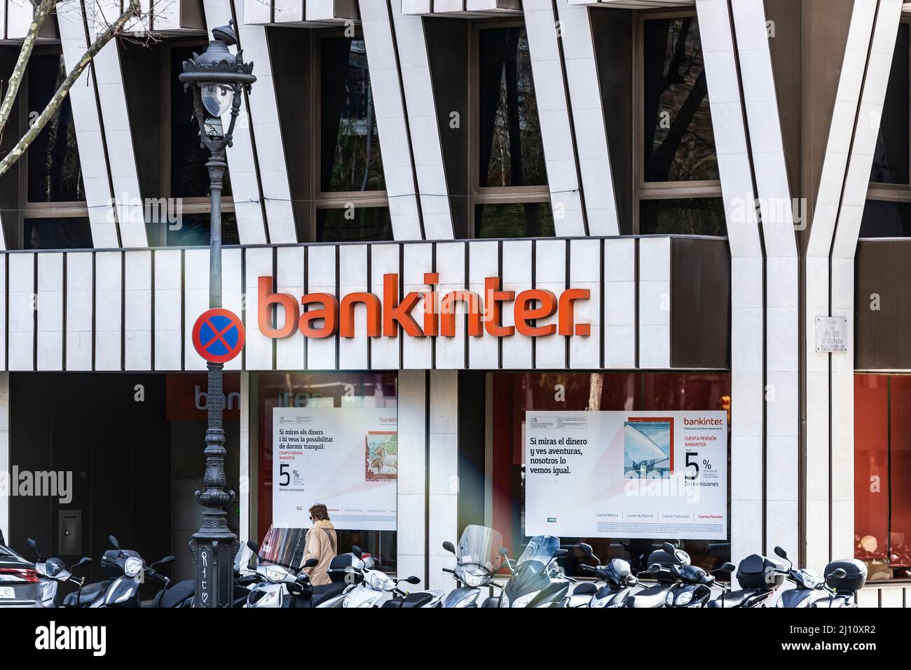Barcelona, Spain - February 24, 2022: Facade and logo of the Bankinter office bank with people around in Barcelona, Catalonia, Spain Stock Photo