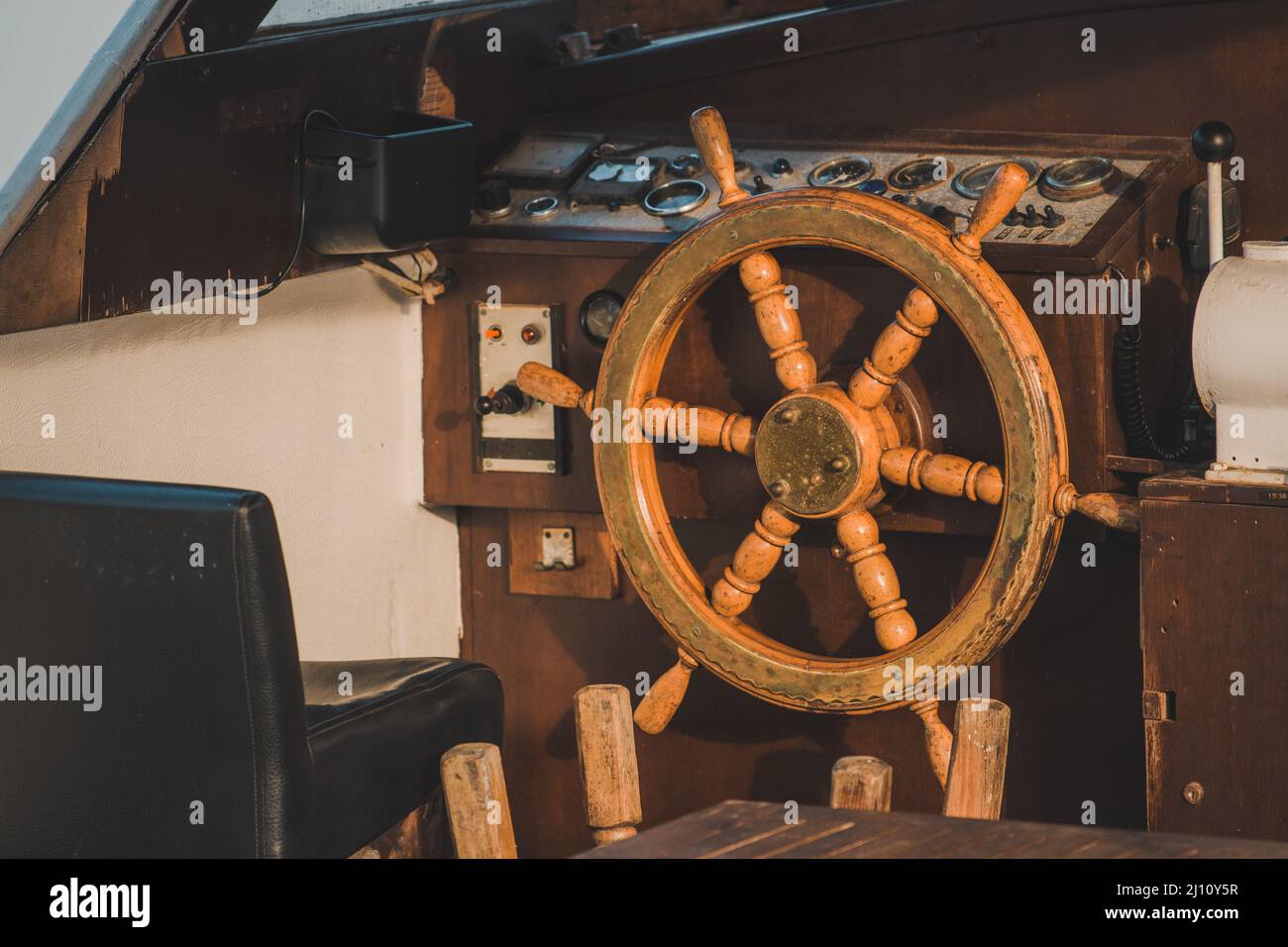 Boat steering wheel in old retro vessel cabin Stock Photo