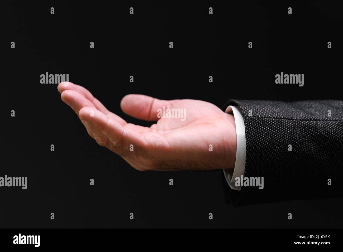 Businessman pleading hand reaching out from the dark, selective focus Stock Photo
