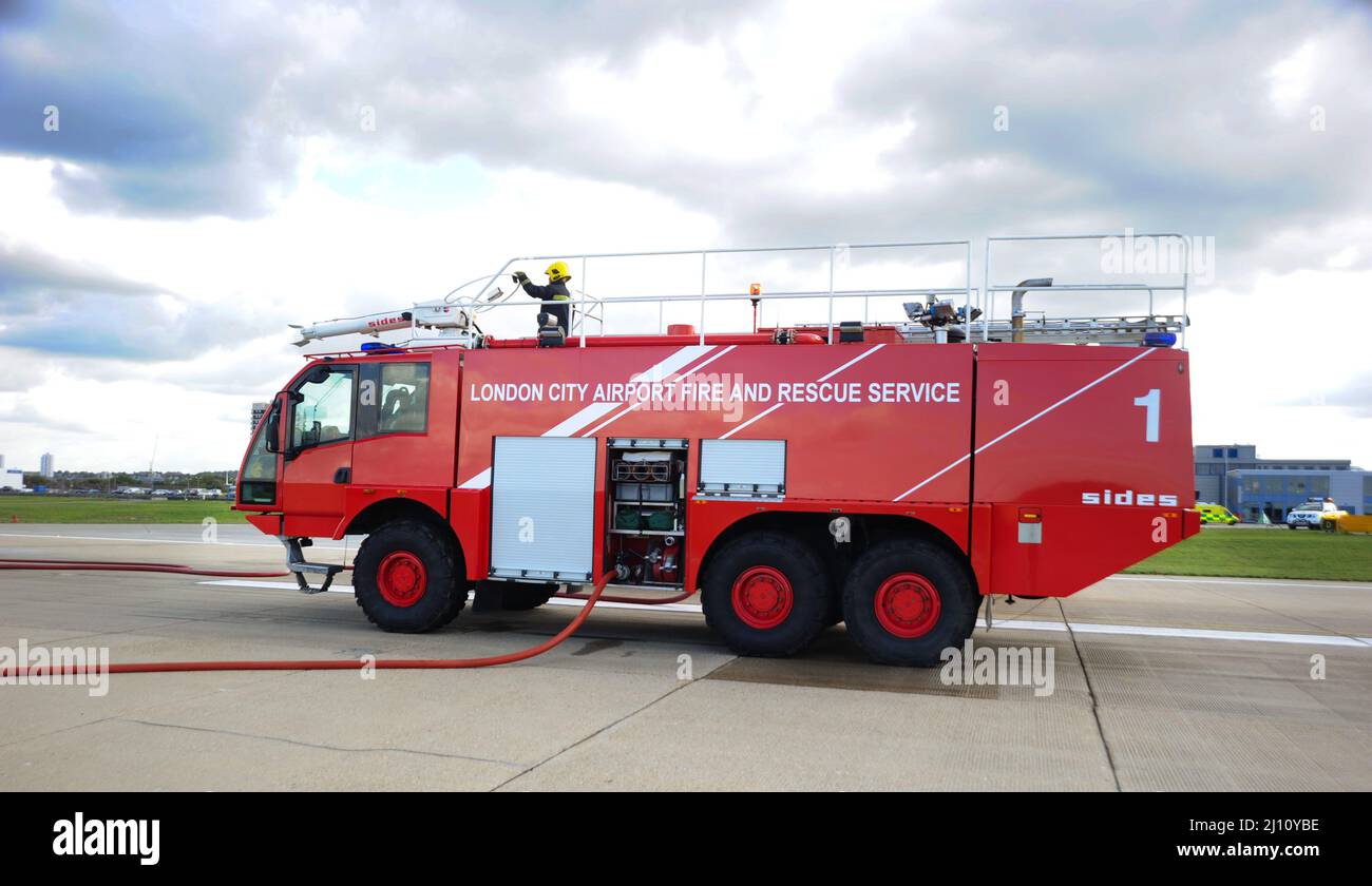 Fire Truck at London City Airport. London City Airport is an international airport in London, England. It is located in the Royal Docks in the London Stock Photo