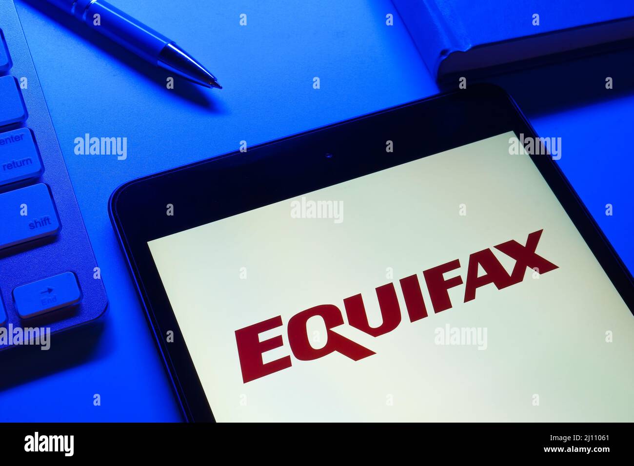 KYIV, UKRAINE - March 13, 2022. Device with Equifax logo on the screen. Stock Photo