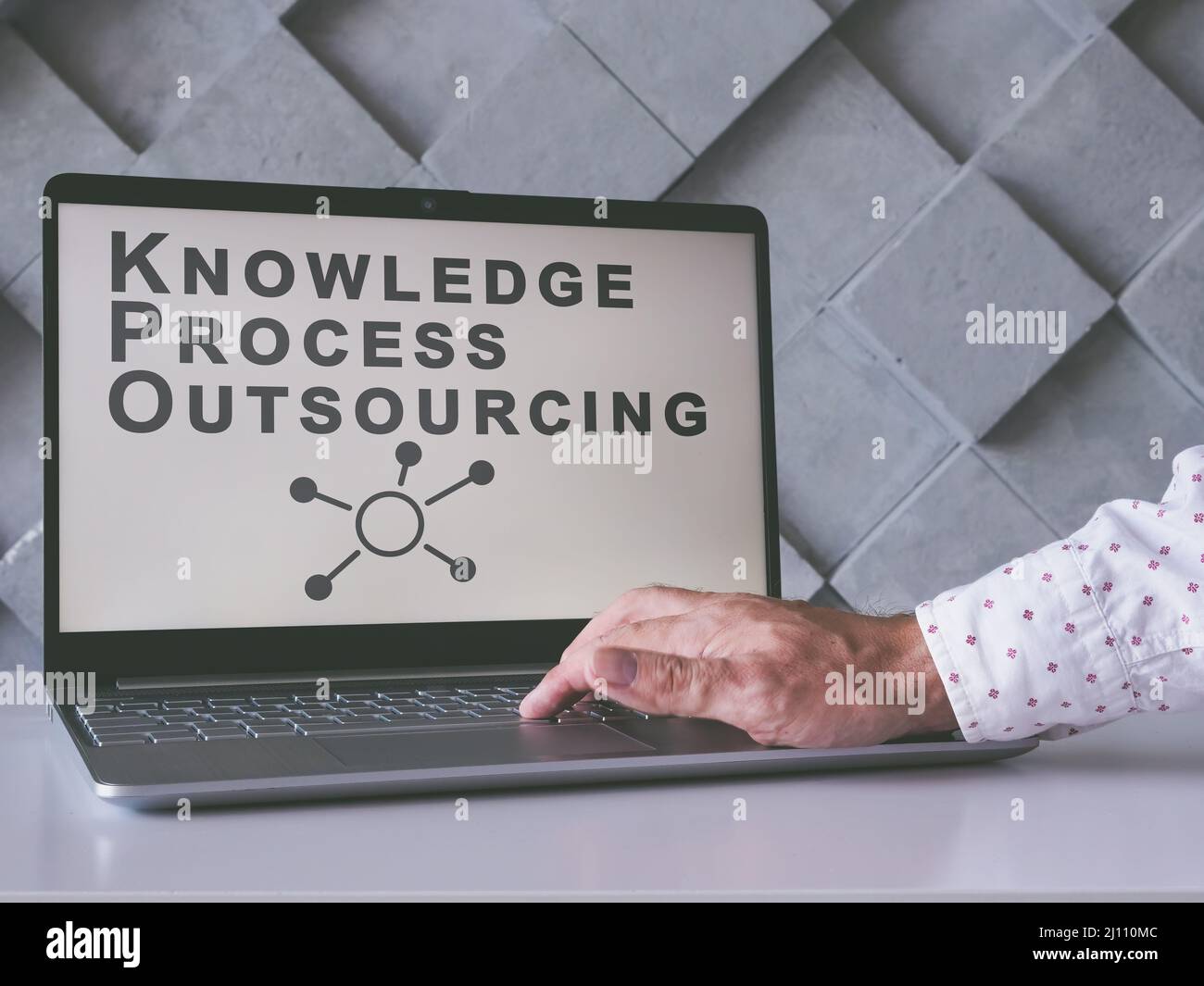 Knowledge Process Outsourcing KPO concept. Man uses laptop. Stock Photo