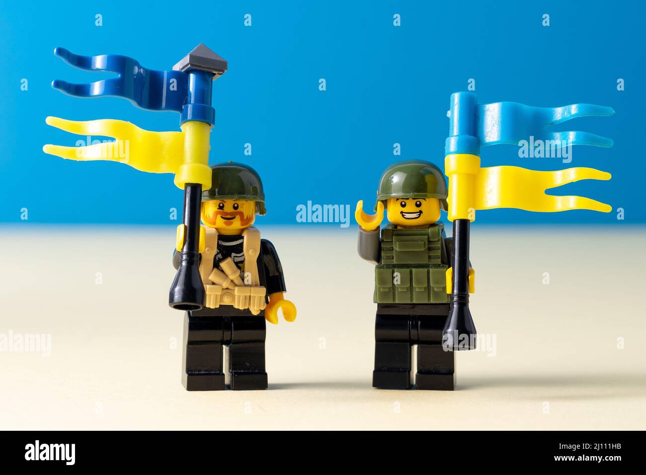 Lego little men with flags of Ukraine. A minifigure toy man holding a blue flag. Soldiers mini figure. Support of the Ukrainian people. Ukraine, Kyiv - March 20, 2022. Stock Photo