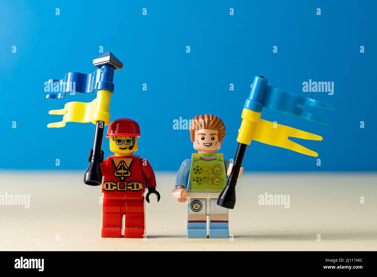 Lego little men with flags of Ukraine. A minifigure toy man holding a blue flag. Support of the Ukrainian people. Ukraine, Kyiv - March 20, 2022. Stock Photo
