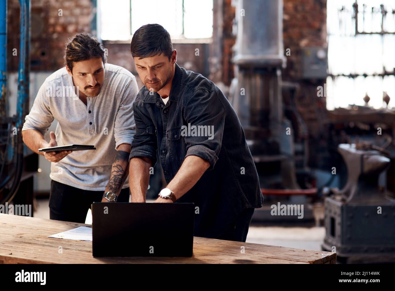 A job worth doing is worth doing together. Cropped shot of two handsome ...