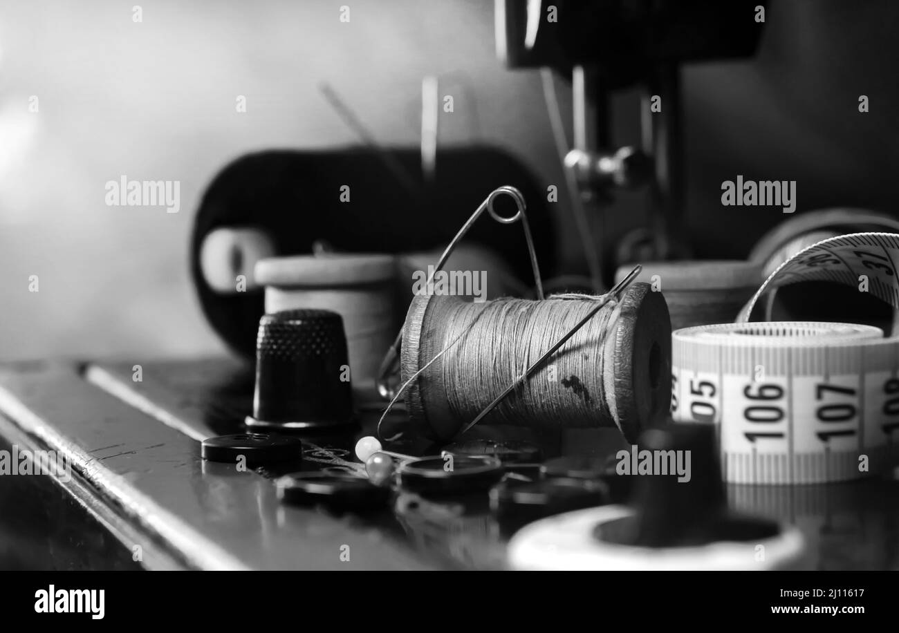 Retro tools for cutting and sewing. Needle with thread, thimble, sewing ...