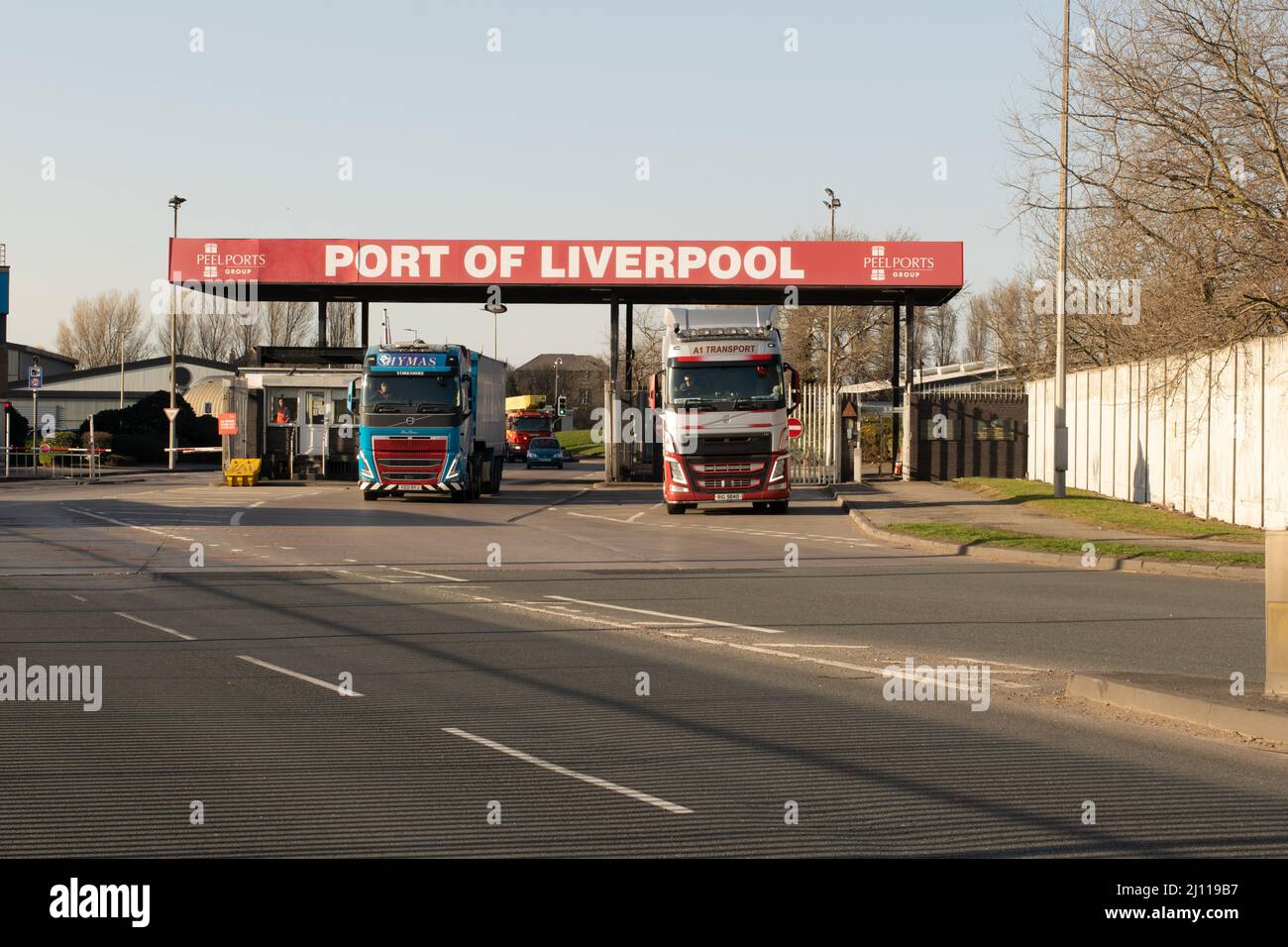 Port of Liverpool sign. Entrance to docks with sign and Peel Ports Group logo. Lorries leaving port. Stock Photo