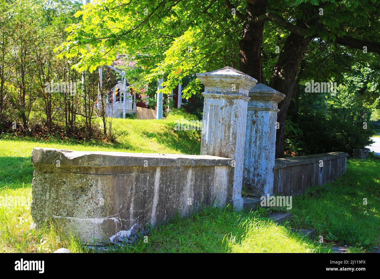 Old concrete gate posts and retaining wall on an empty lot where a house once stood, downtown St. John's, NL Stock Photo