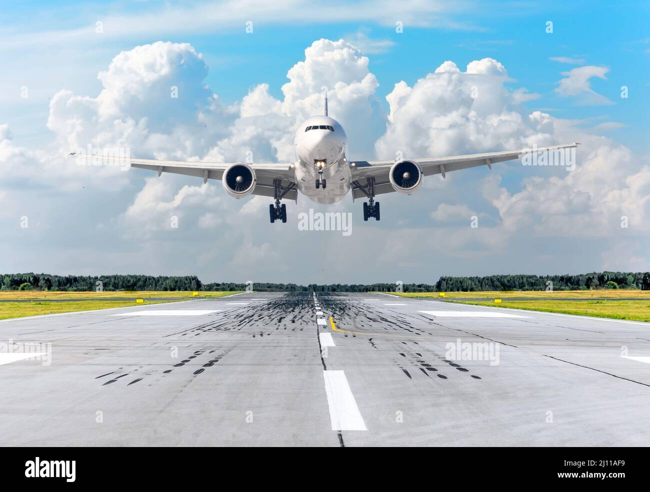Passenger airplane landing at in clouds sky on a runway Stock Photo Alamy
