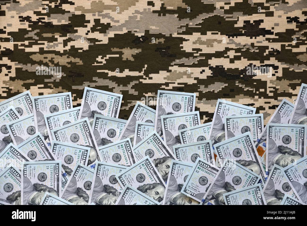 US dollar bills on fabric with texture of Ukrainian military pixeled ...