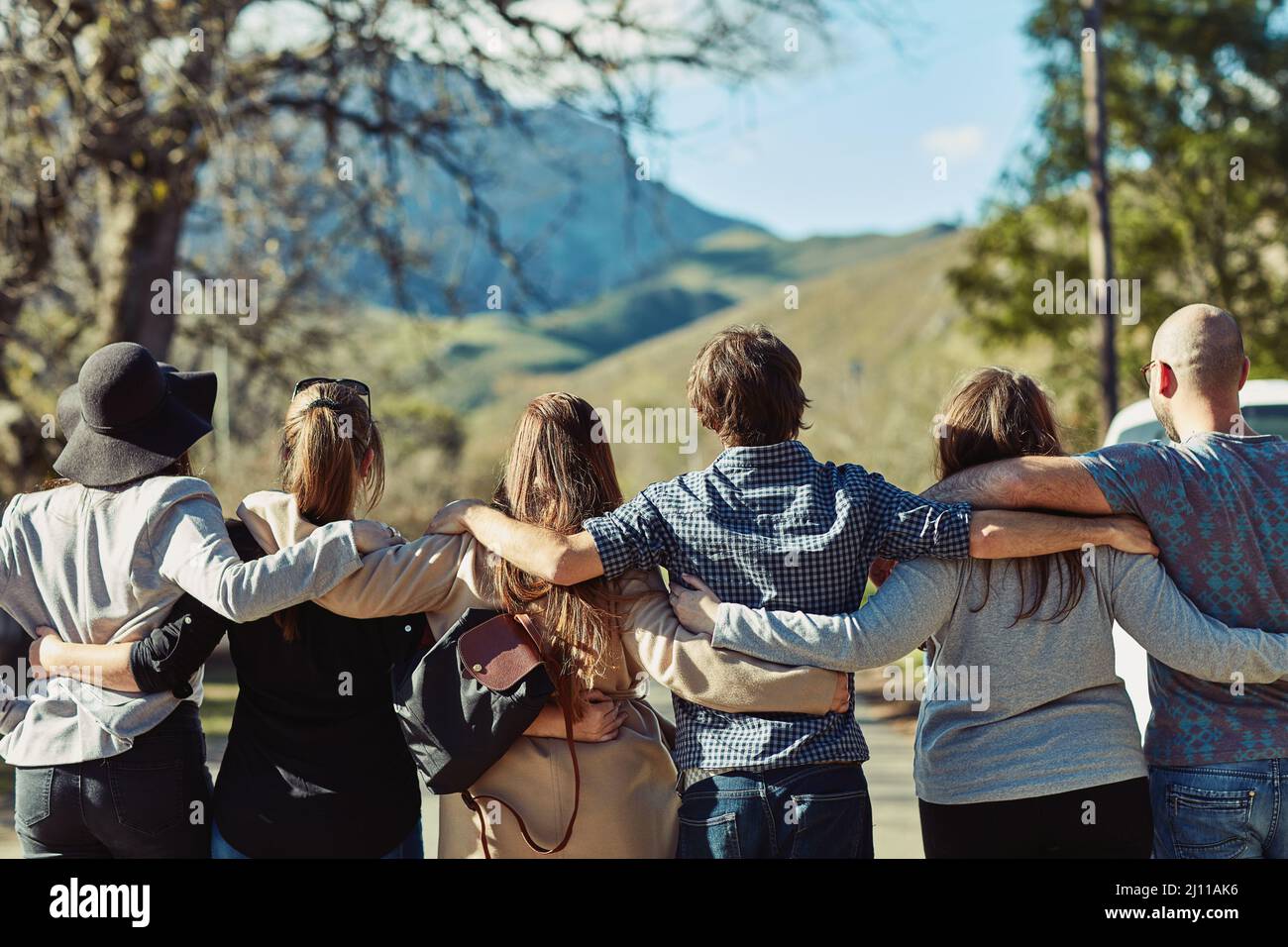 Seeing beautiful places with beautiful people. Rearview shot of a group of friends standing together. Stock Photo