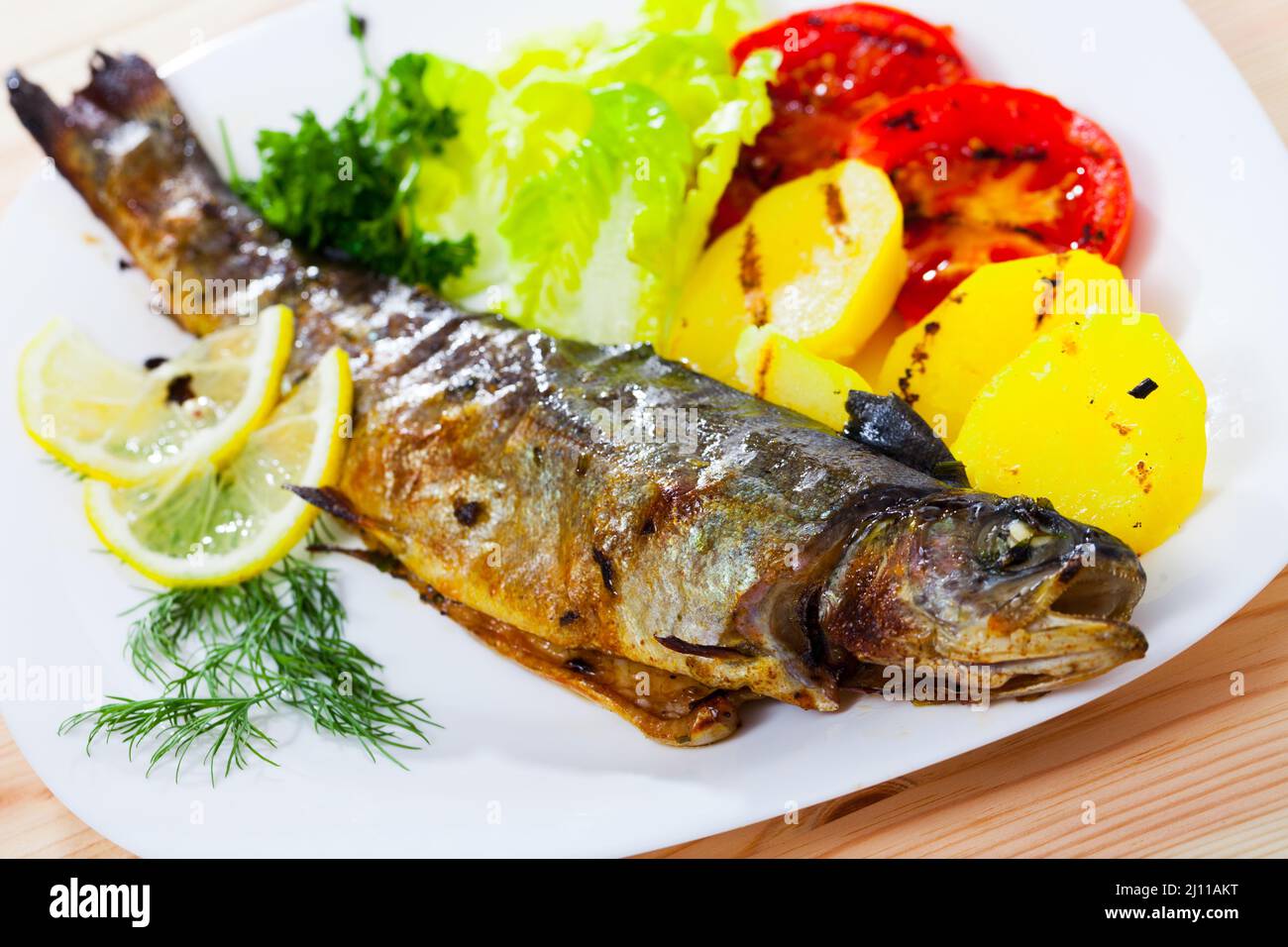 Grilled trout with vegetable garnish Stock Photo Alamy