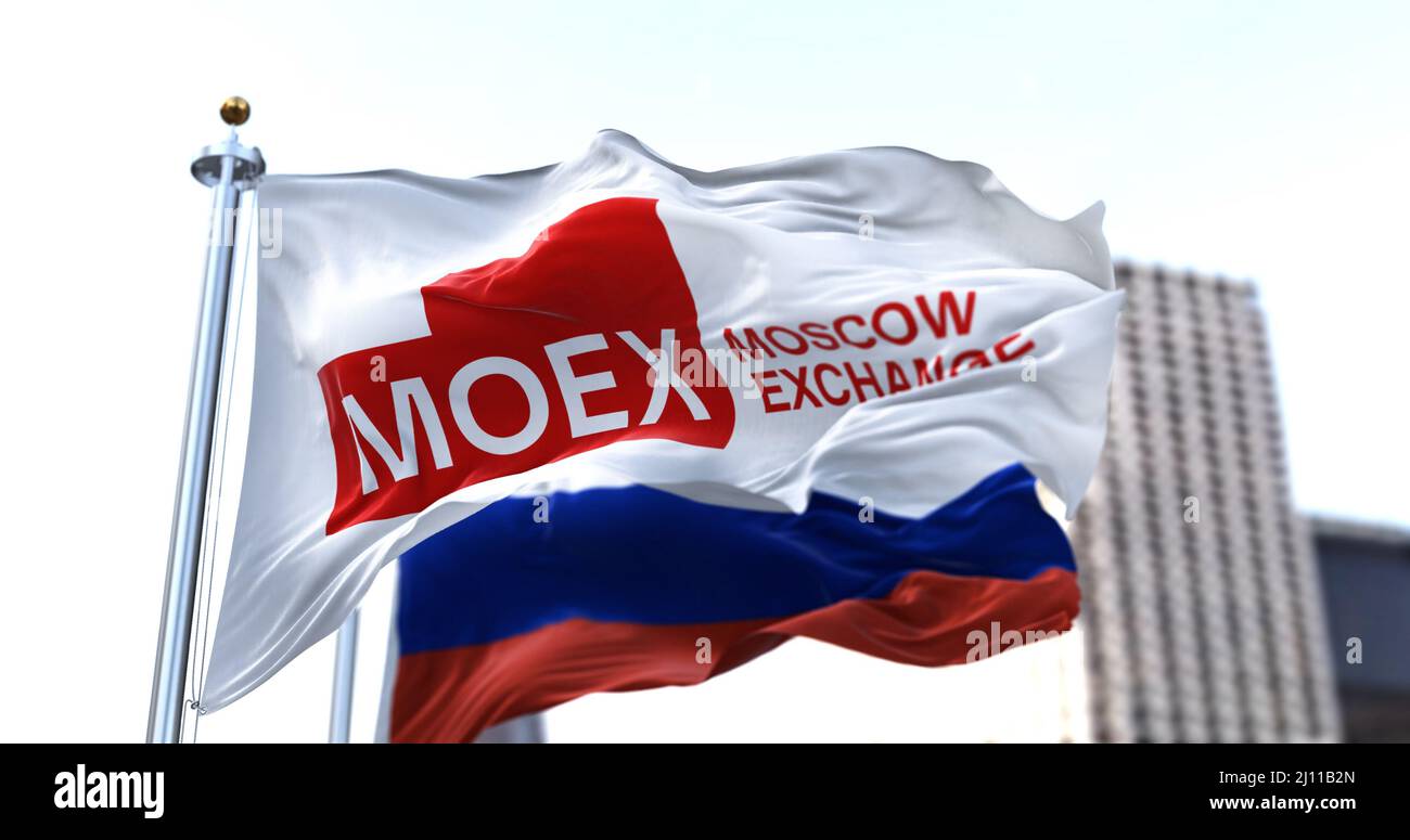 Moscow, RUS, March 2022: the flag of the Moscow Exchange waving in the wind with the Russian national flag blurred in the background. The Moscow Stock Stock Photo