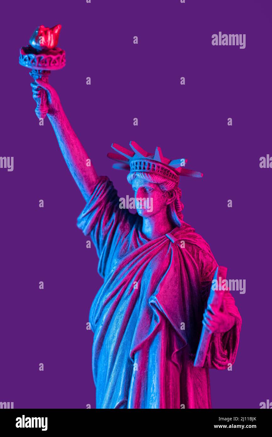 Statue of liberty close up with neon illumination background. USA