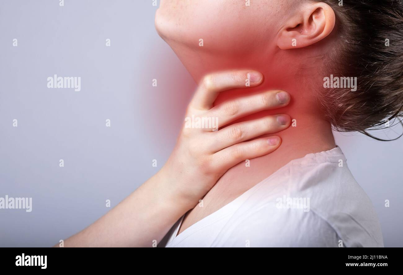 Sore throat, pain or ache in neck closeup. Person holding thyroid inflammation. High quality photo Stock Photo