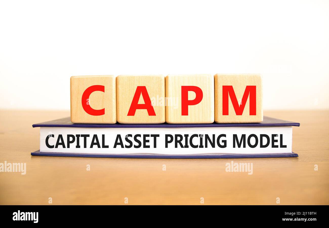 CAPM capital asset pricing model symbol. Concept words CAPM capital asset pricing model on cubes on a beautiful white background. Business CAPM capita Stock Photo