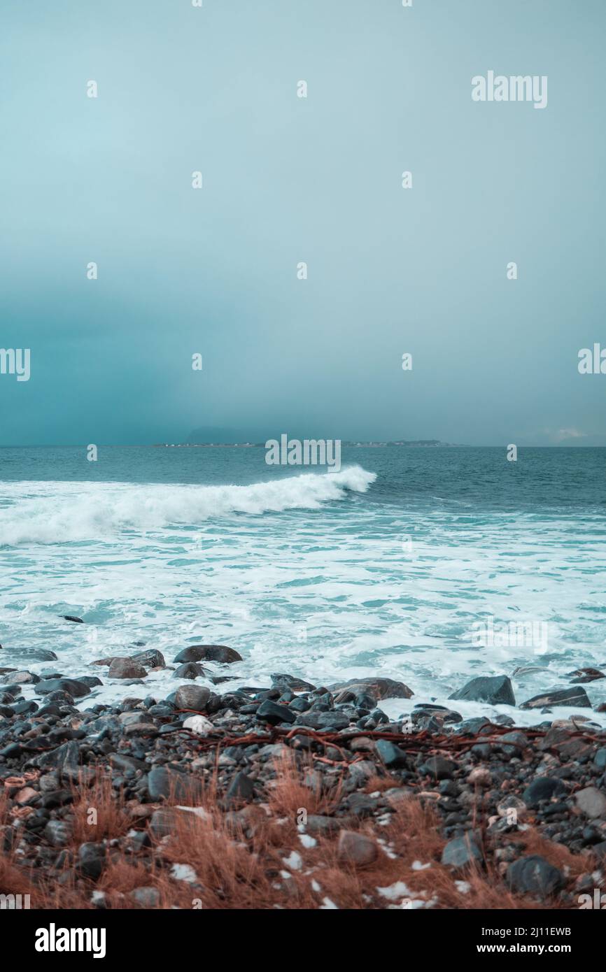 Vertical shot of a sea waves foam taken from a beach Stock Photo - Alamy