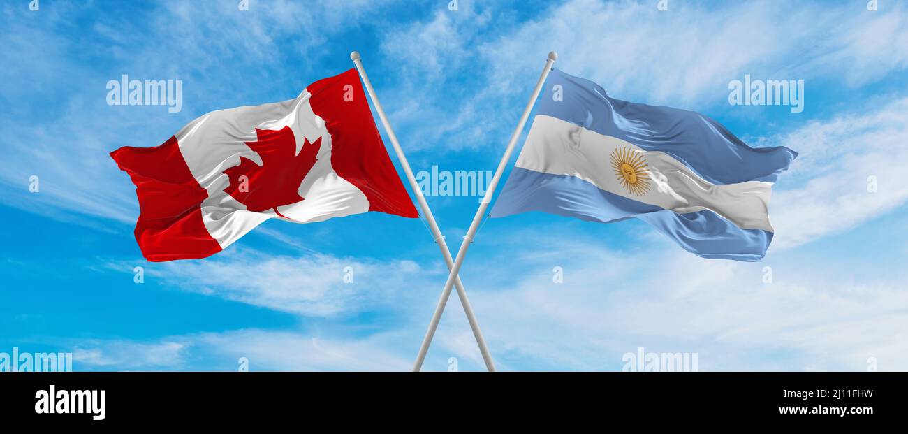crossed national flags of Canada and Argentina flag waving in the wind ...