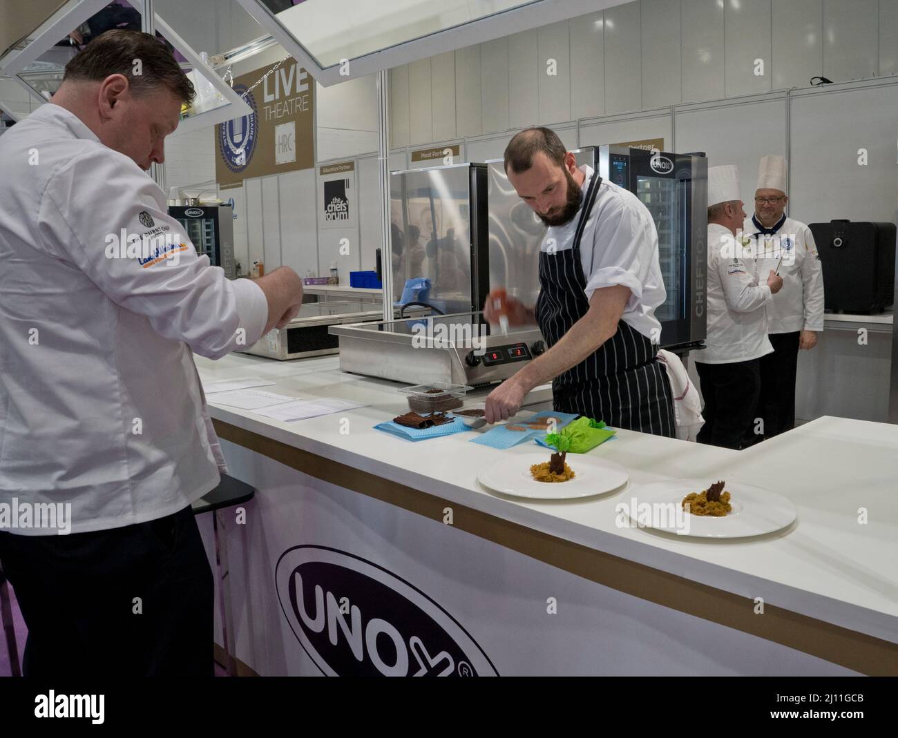 Trainee chefs prepare food for visitors and traders at the IFE 2022