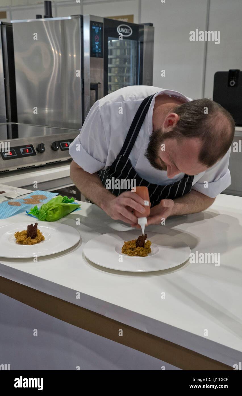 Trainee chefs prepare food for visitors and traders at the IFE 2022