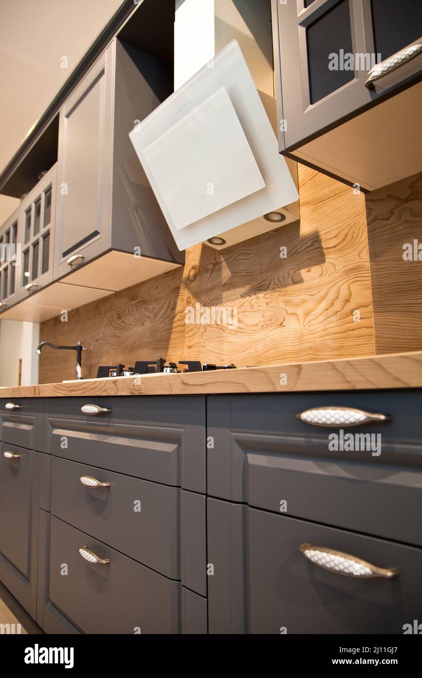 Interior of luxurious wooden modern kitchen equipment and grey
