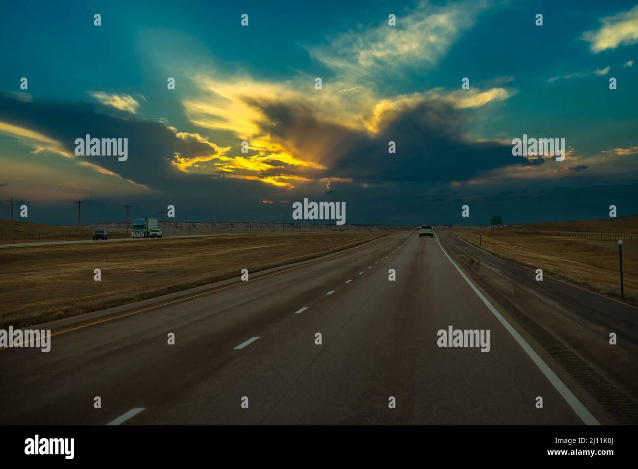 With dark clouds and a nice blue sky along an interstate in South Dakota Stock Photo Alamy