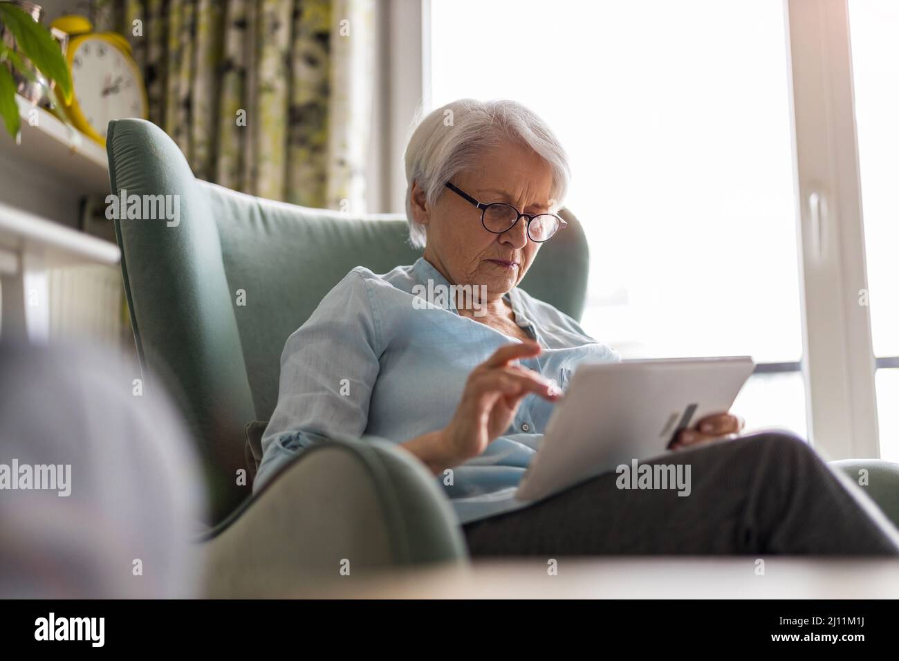 Senior woman using a digital tablet at home Stock Photo