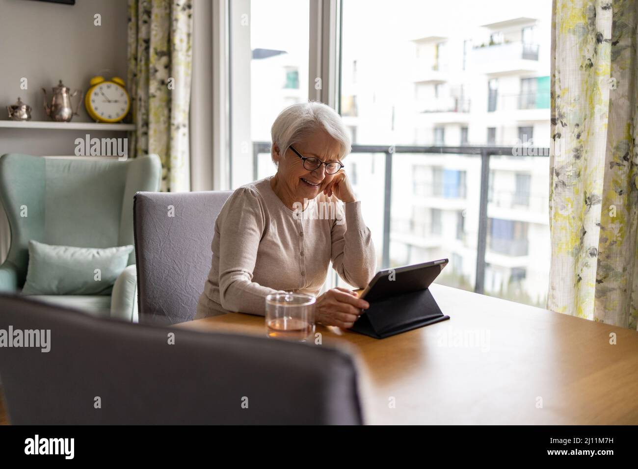 Senior woman using a digital tablet at home Stock Photo