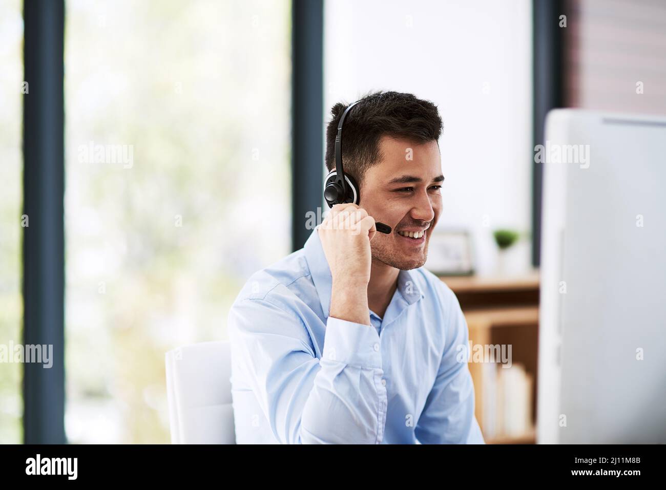 He knows how to keep the attention of his customers. Shot of a happy ...