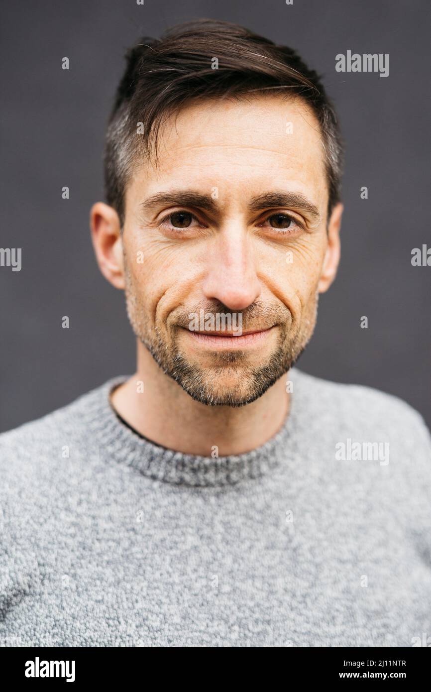Portrait of a man in casual clothes, against a grey background Stock Photo