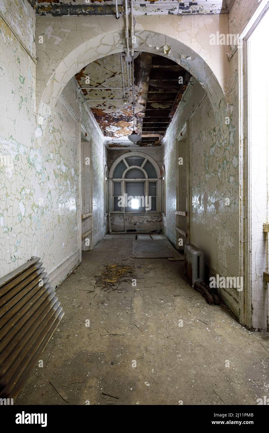 Hallway inside an abandoned asylum. Stock Photo