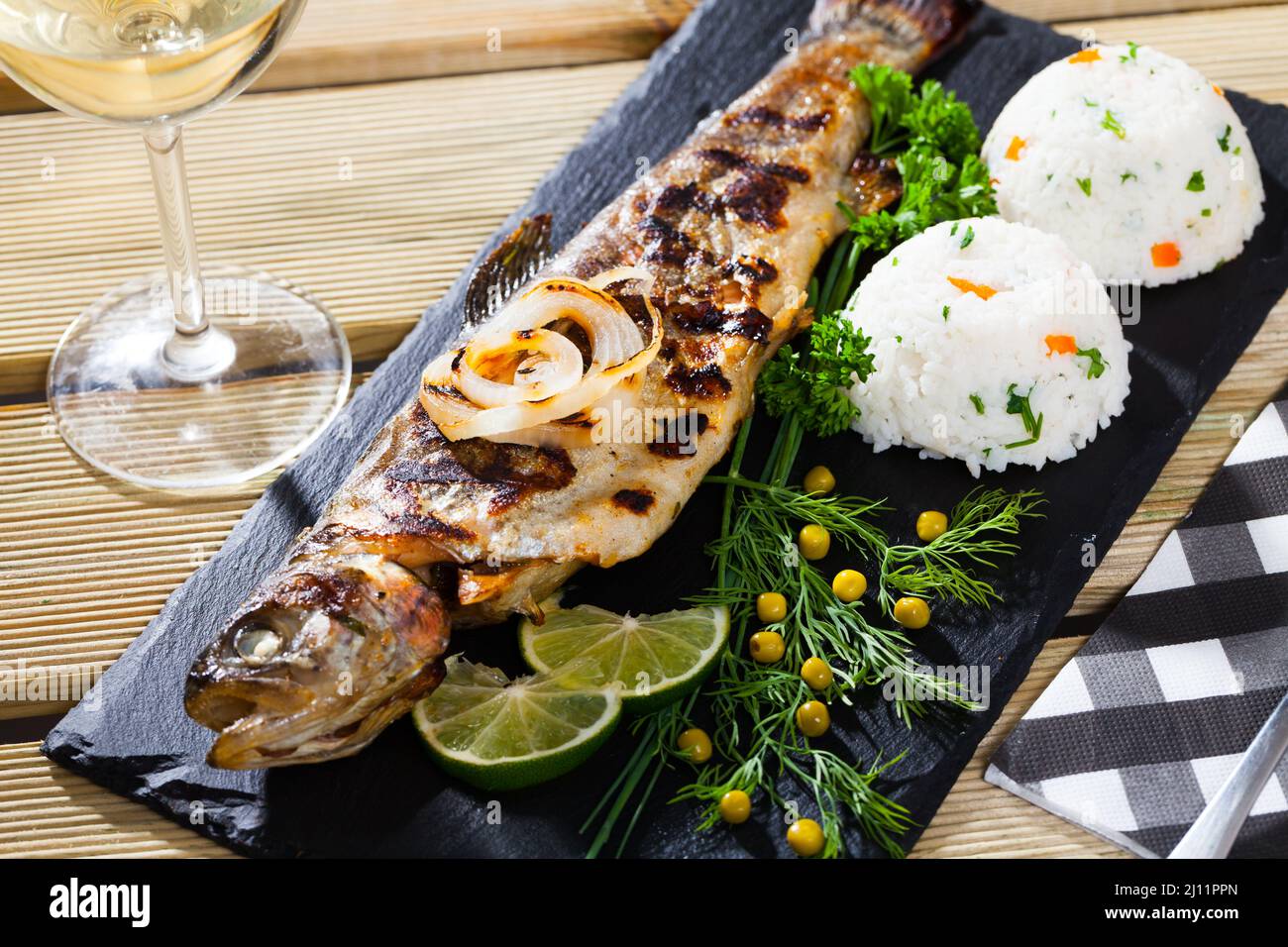 Baked trout with wine and garnish of rice Stock Photo Alamy