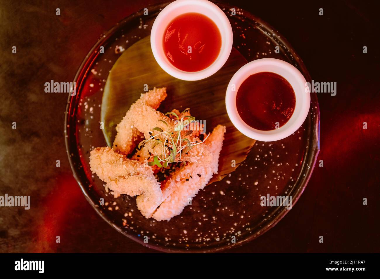 Breaded chicken wings with two Mexican sauces Stock Photo Alamy