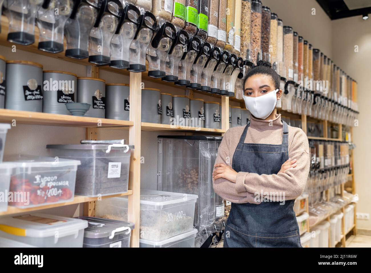 Portrait of african american woman owner of sustainable small local business wearing eco-friendly cotton mask Stock Photo