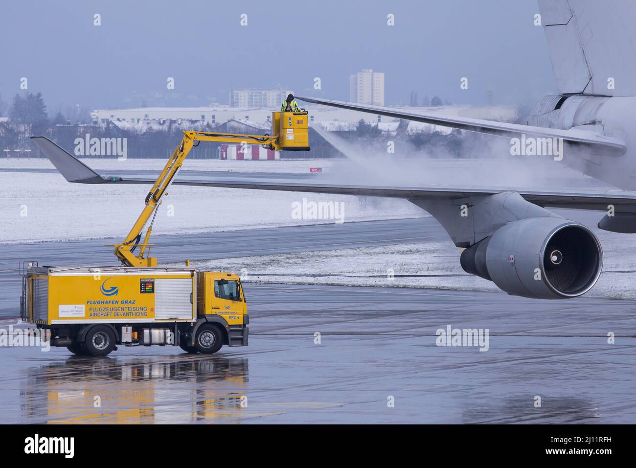 Anti-icing in progress at a Boeing 747 at airport Graz in Austria during cold weather conditions Stock Photo