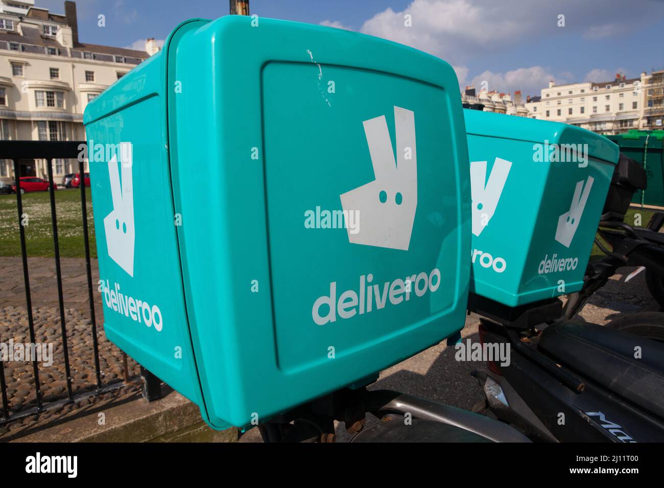 Deliveroo courier boxes on the rear of motorbikes in Brighton, East Sussex Stock Photo