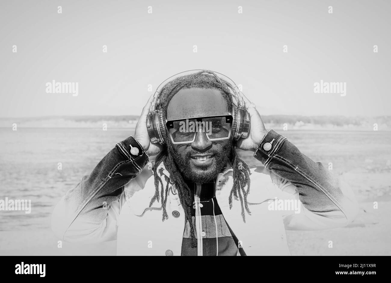 https://c8.alamy.com/comp/2J11X9R/handsome-attractive-young-african-american-man-with-dreadlocks-listening-music-outdoor-white-and-black-photo-street-photo-white-rock-bc-canada-mar-2J11X9R.jpg