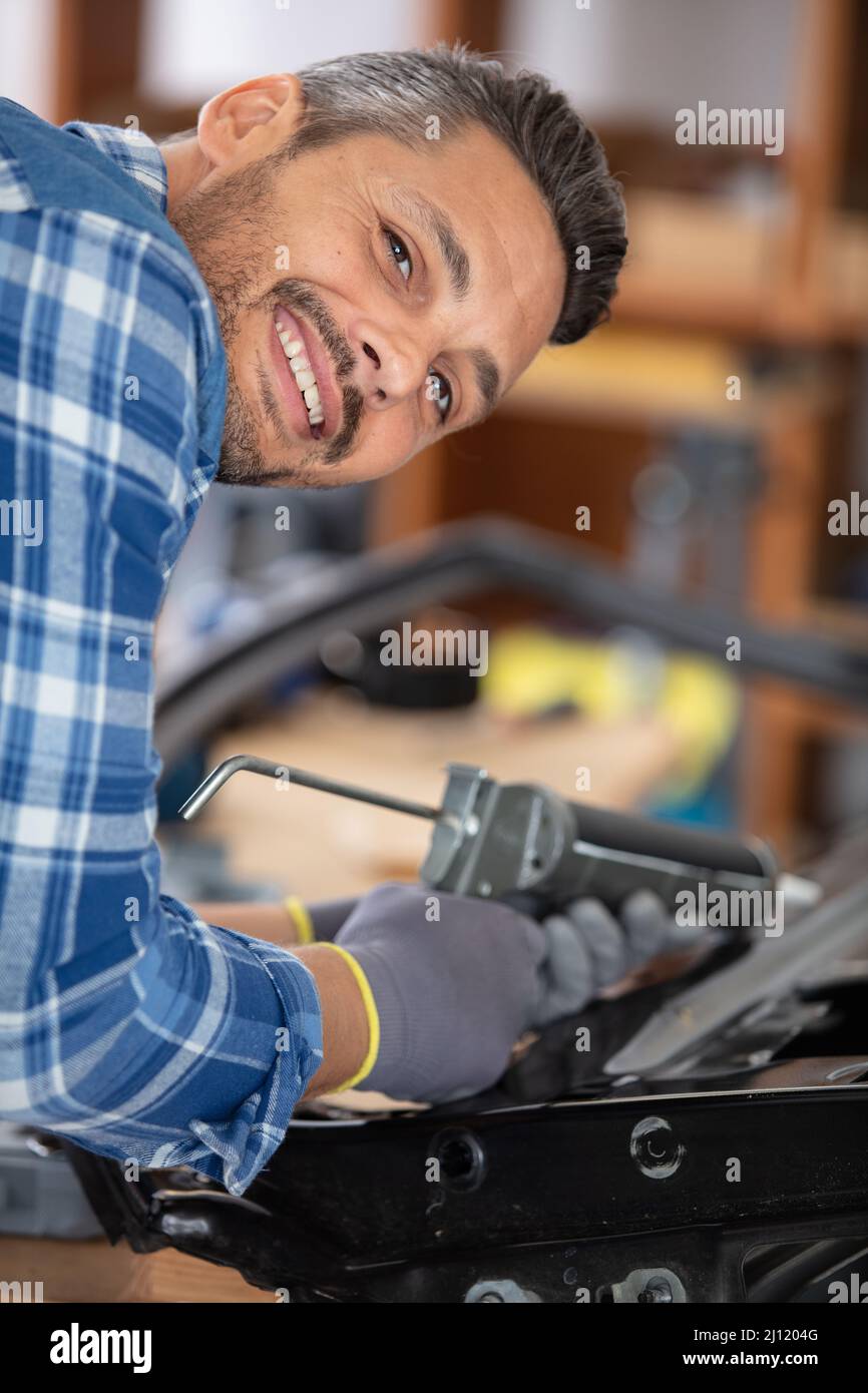 happy worker repairing a car body Stock Photo
