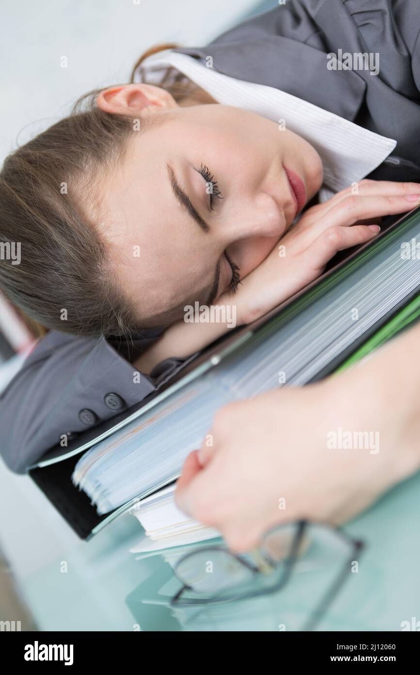 young businesswoman sleeping on folders at workplace Stock Photo - Alamy