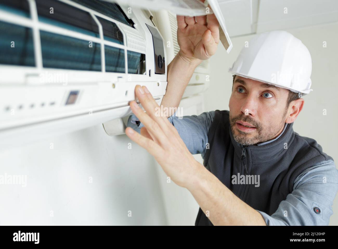 male repairman connecting air conditioner pipes Stock Photo Alamy